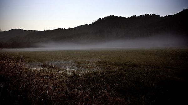 Pictures of Natural Scene - Tall and Misty Hills, Green to Gray Grass, a Water Pool in the Middle