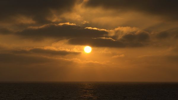 landscape photography - The Rising Sun Over the Peaceful Sea, Clouds Are Thus Golden