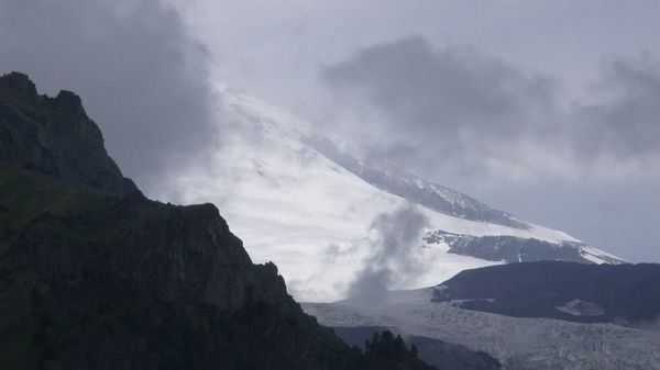 natural photos - A Snow-Capped Mountain, Smoke is Pouring, is a Fire Breaking Out?