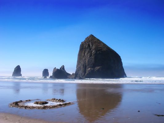 click to free download the wallpaper--Beautiful Image of Nature, Haystack Rock Under the Blue Sky, the Peaceful Sea