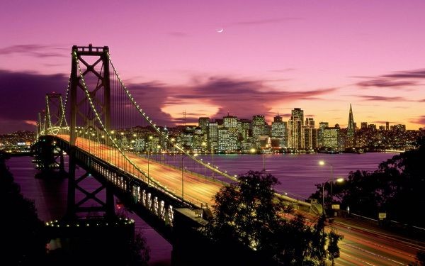 click to free download the wallpaper--Beautiful Sceneries of the World - San Francisco Bridge California, Bridge in All Lights, Tall Buildings Under the Purple Sky, Romantic Scene