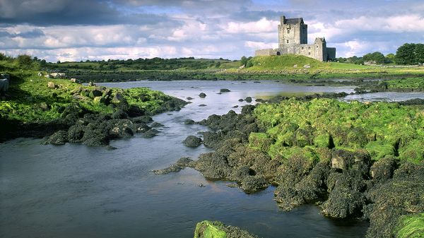 click to free download the wallpaper--Free Download Natural Scenery Picture - All Green Plants by the Clear River, a Tall Castle Reaching the Blue Sky