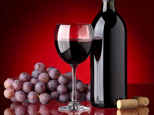 click to free download the wallpaper--Free Fruits Wallpaper, Red Wine Bottle, Ripe Grapes Around