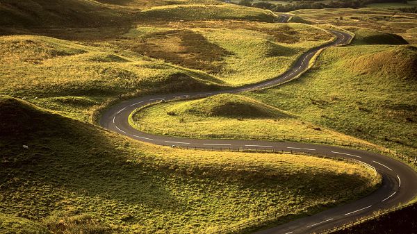 click to free download the wallpaper--Free Pics of Rural Scene - The Winding Road Seems Naturally Formed, Green Plants Along Both Sides
