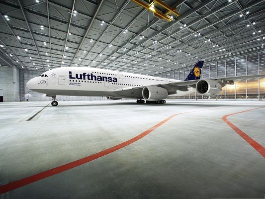 click to free download the wallpaper--Free Plane Wallpaper, Lufthansa 380 in Open Ground, Under Shinning Lights