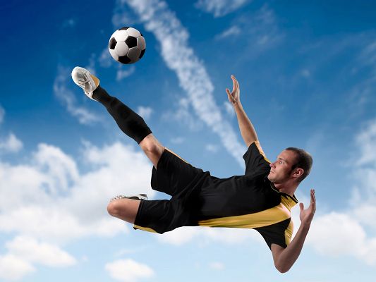 click to free download the wallpaper--Free Sports Wallpaper, Football Player Kicking The Ball, Handsome Pose