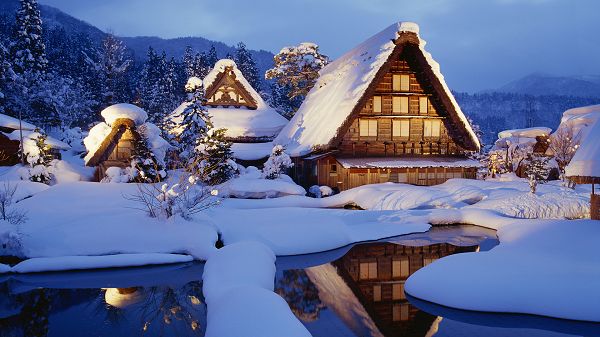 click to free download the wallpaper--Houses Covered with Thick Snow, Lights Are Turned on, Warm Light is Generated, Snowy Winter Days Are Made Comfortable - HD Natural Scenery Wallpaper