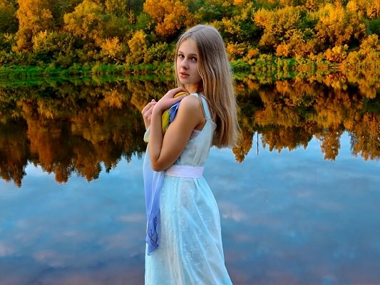 click to free download the wallpaper--Photos of Cute Girl, Beautiful Girl by the Peaceful Lake, Golden Tall Trees Reflection