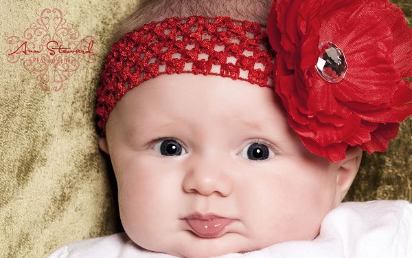 wallpaper of super baby: a cute baby with a big red flower on th head ,click to download